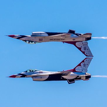 Jet flying upside down over another jet