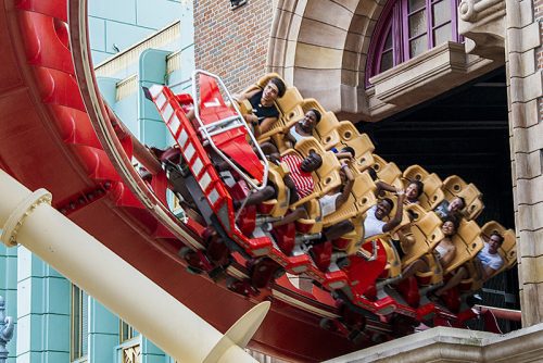 People riding red roller coaster