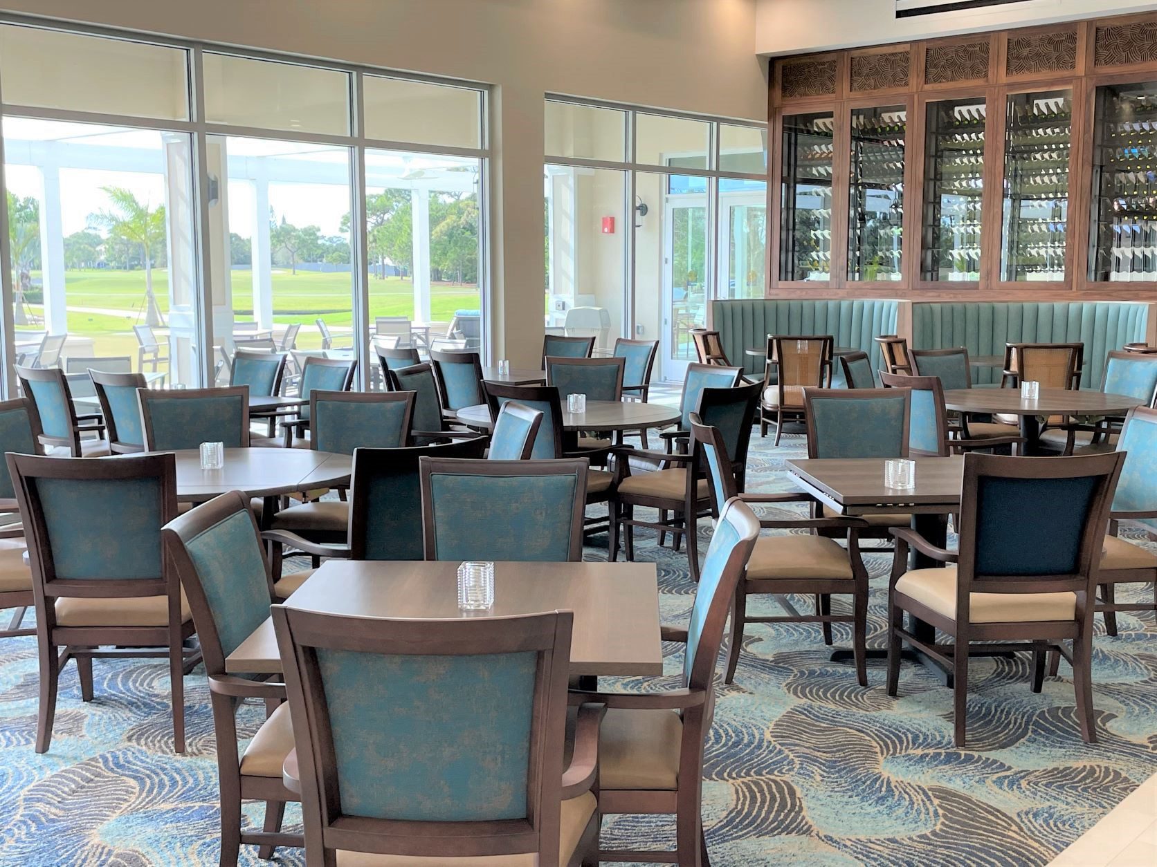 Eating area with brown tables and green/tan chairs