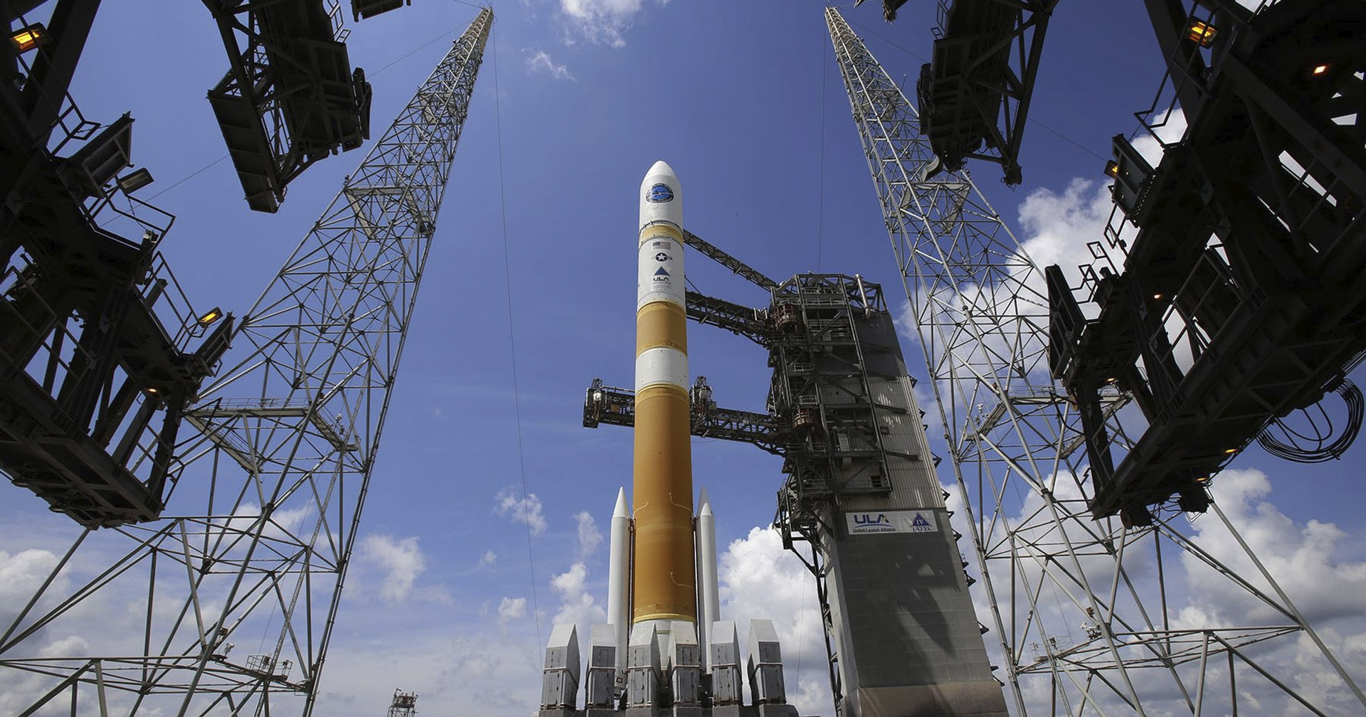 Orange/white rocket with gray launch pad