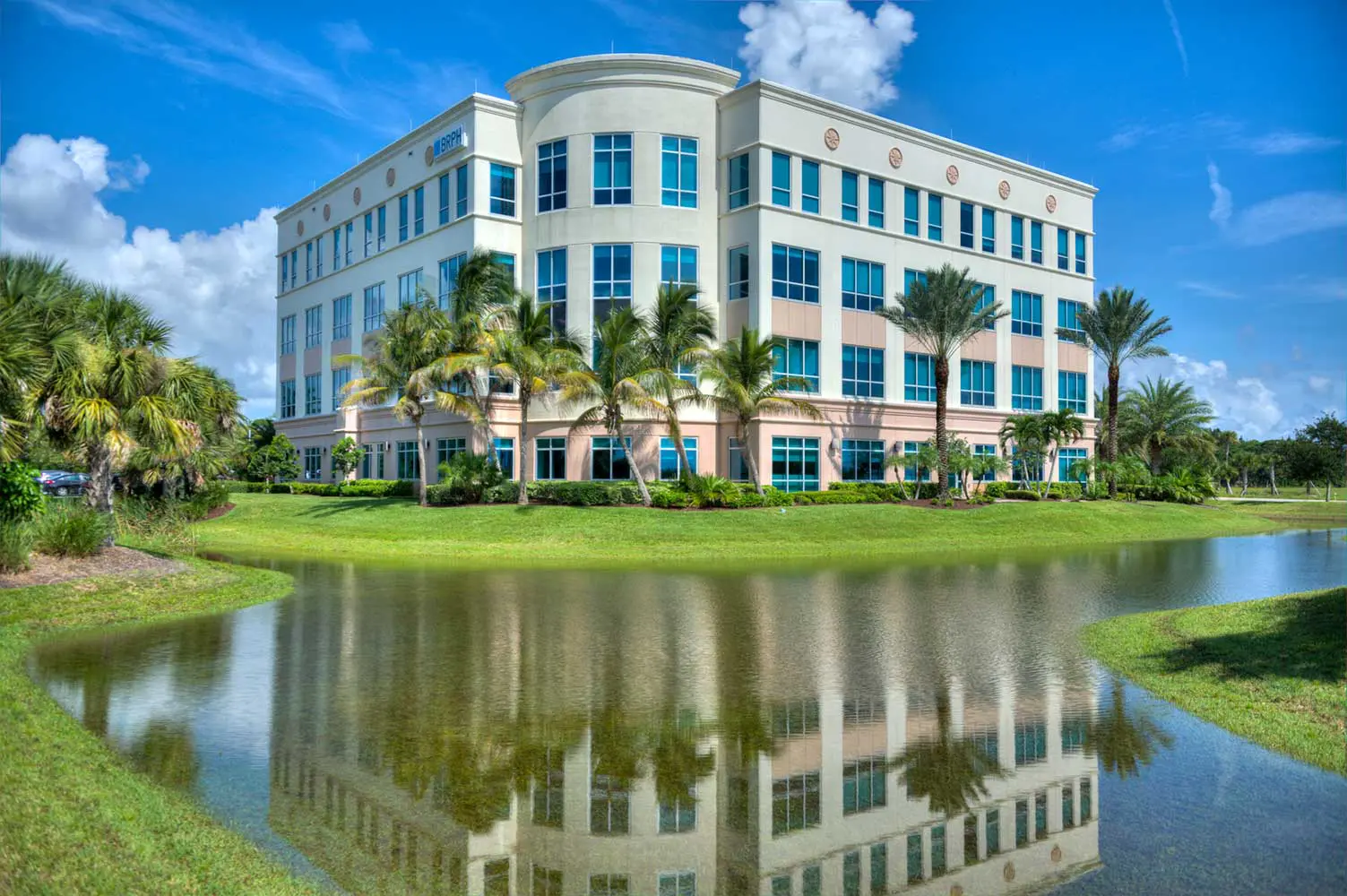 Ext white/tan building with lake in front