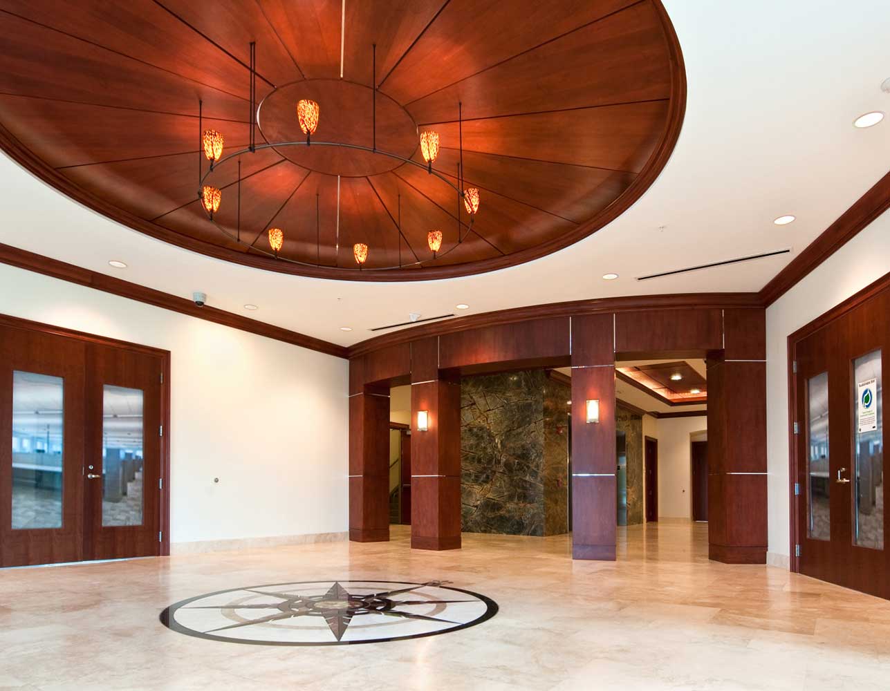 Lobby of BRPH building with brown wood columns and beige flooring