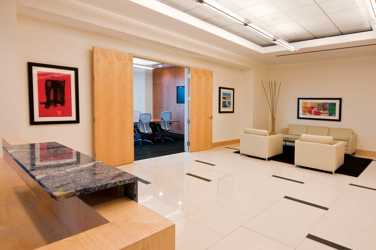 Reception area at BRPH with white floor and beige couch/chairs