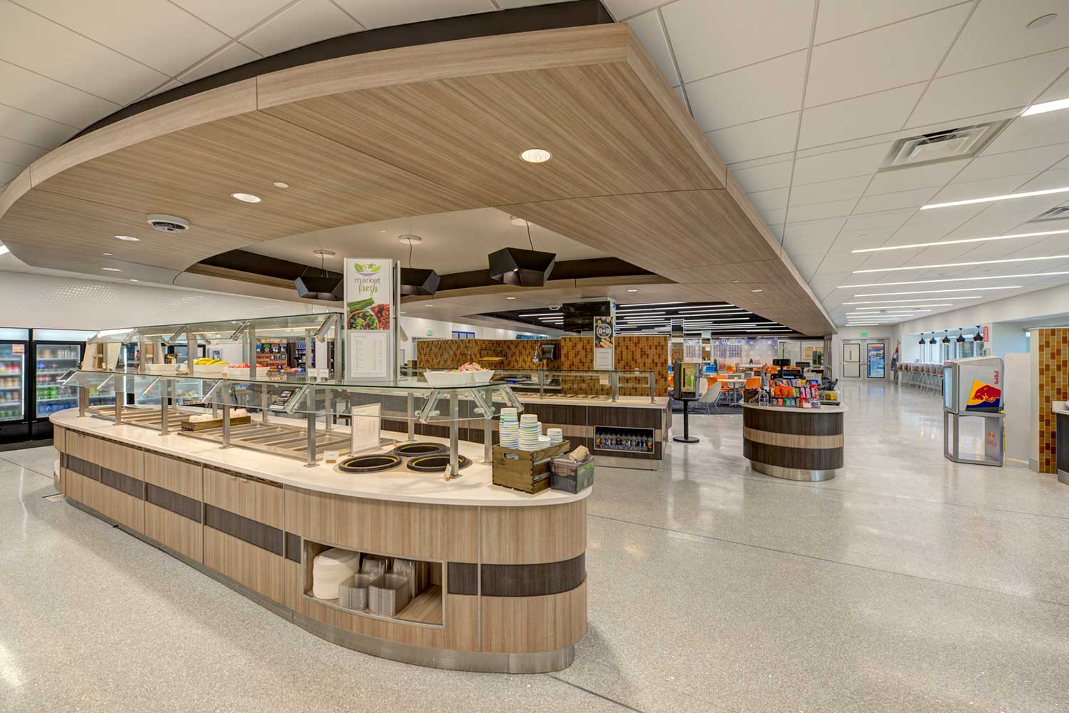 Cafeteria with brown food stations and gray floors