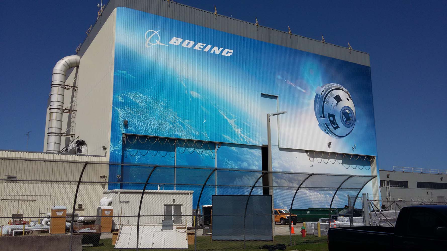 Ext Boeing gray hangar with blue space design on front
