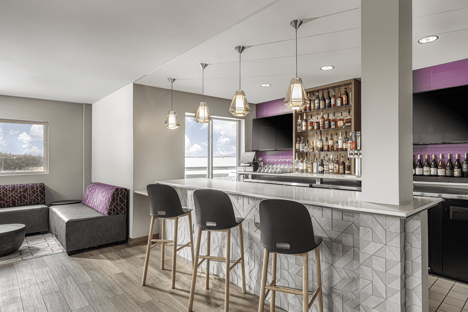 Gray bar with black stools and gray/purple walls