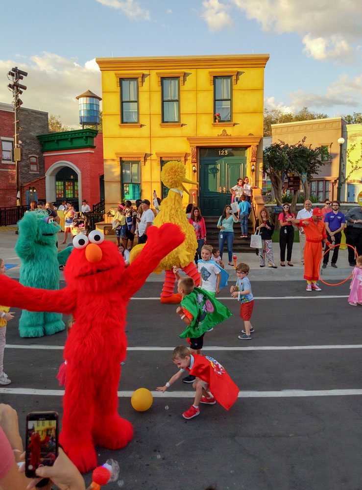 Sesame Street characters playing with kids