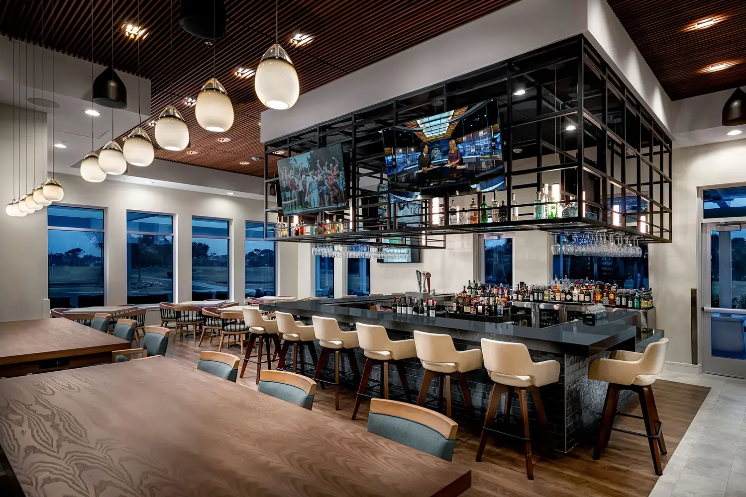 Black liquor bar with brown/tan stools and brown tables