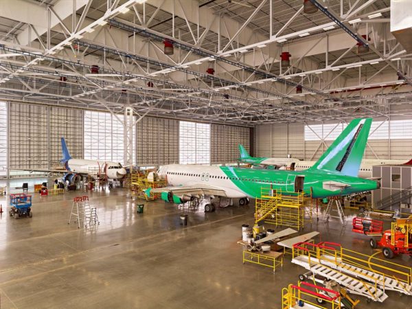 The Georgia Advanced Manufacturing Training Center - Large interior shot of hangar with several commercial planes inside