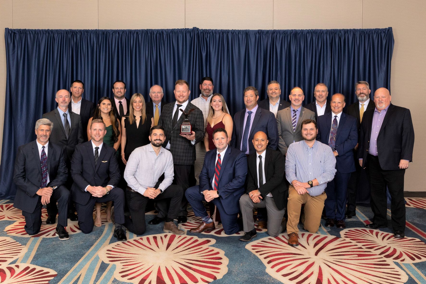 group of people posing with award