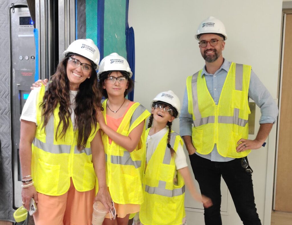 family in hard hats and safety vests
