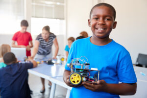 boy holding robotic car