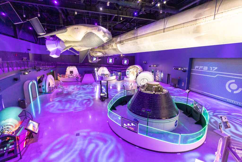 Gallery with spacecraft and purple lighting