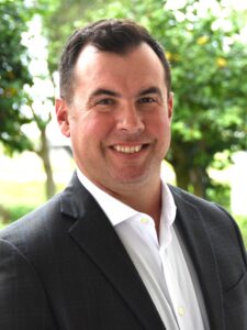 Man in white shirt and blue jacket