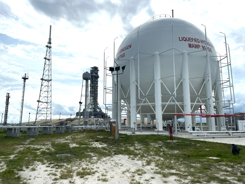spherical tank with launch pad in distance
