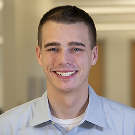 young man with short hair smiling