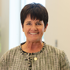 lady with short black hair smiling